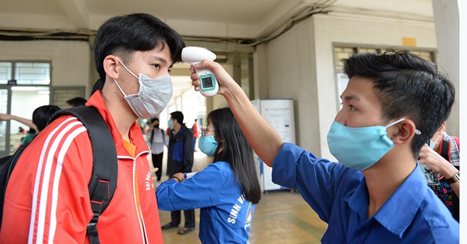 Sinh viên xếp hàng chờ tới lượt đo thân nhiệt ở trường, sau kỳ nghỉ kéo dài vì dịch Covid-19 - Ảnh 7.